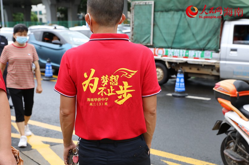 在海南华侨中学（高中部）考点，不少家长穿着红色衣服前来为考生加油。人民网记者 孟凡盛摄