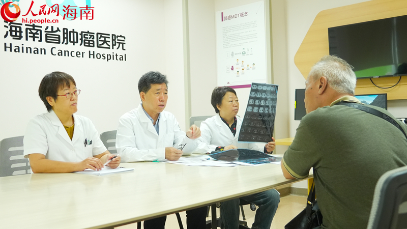海南省肿瘤医院胸部肿瘤中心主任王长利教授(左二)在接诊患者。人民网记者 孟凡盛摄